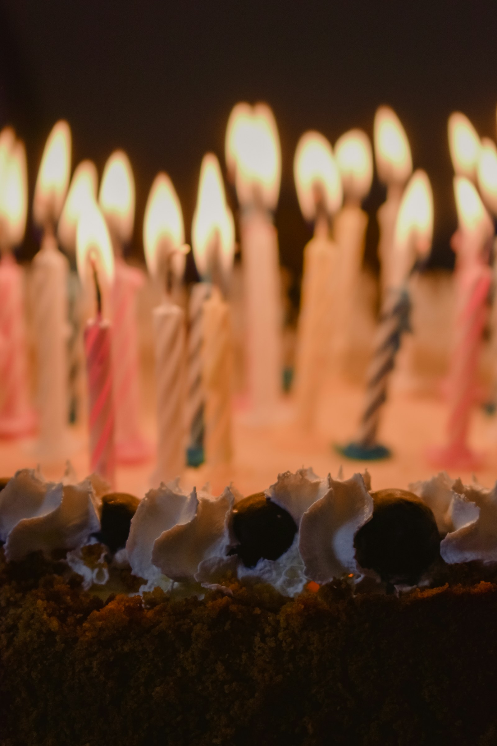 Celebration cake topped with glowing candles