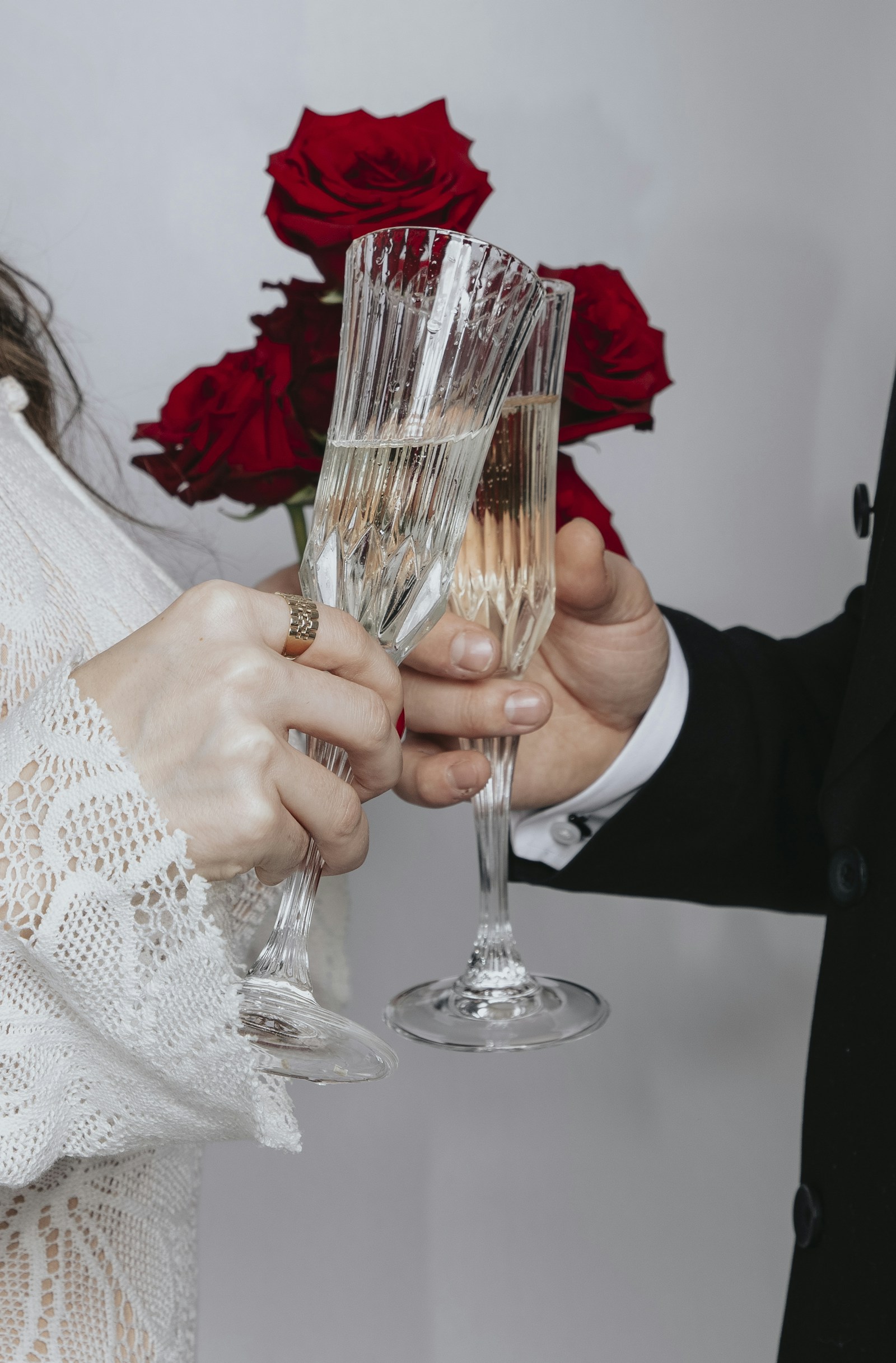Hands raising champagne glasses in a toast