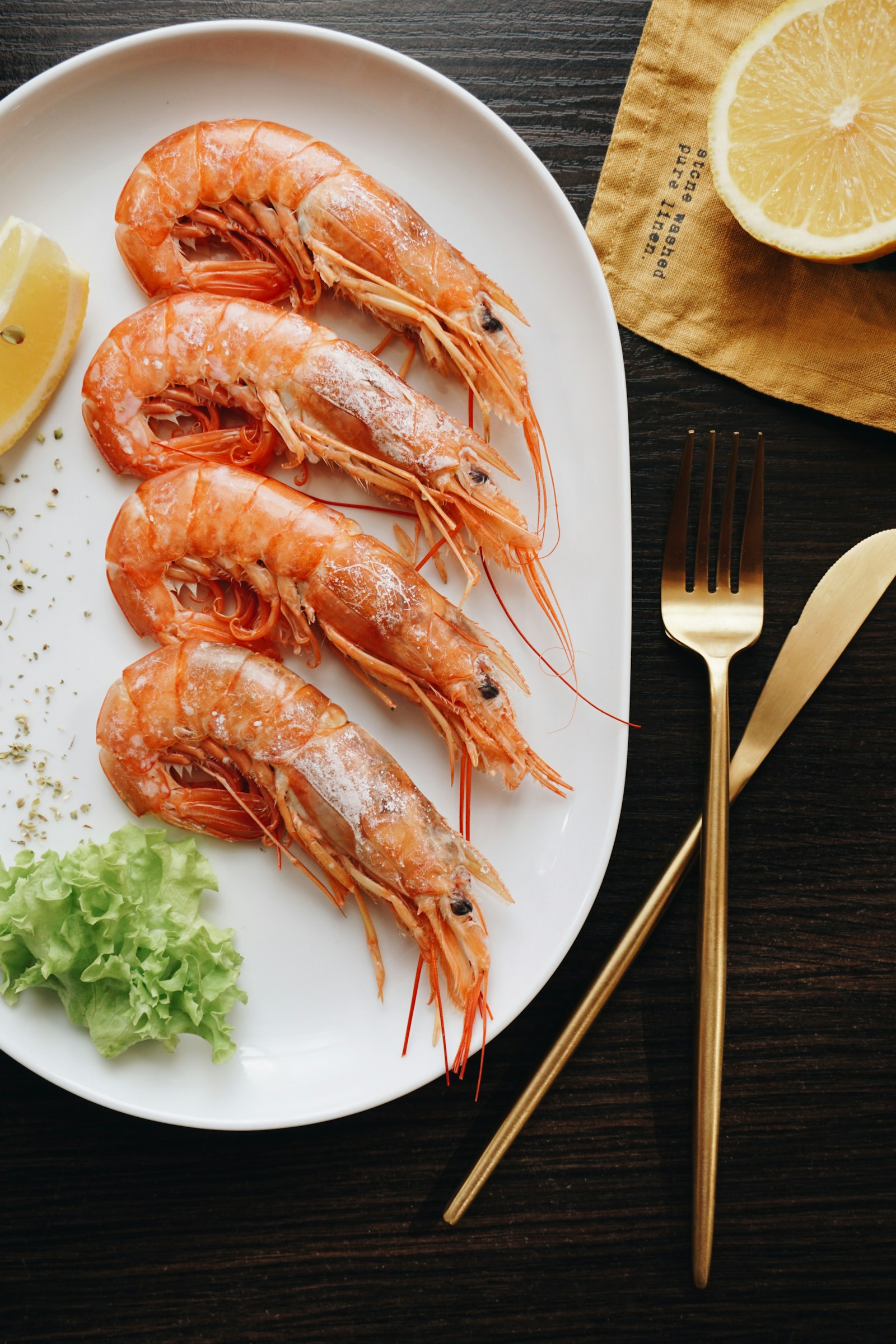 Plated prawns with lemon and fresh herbs