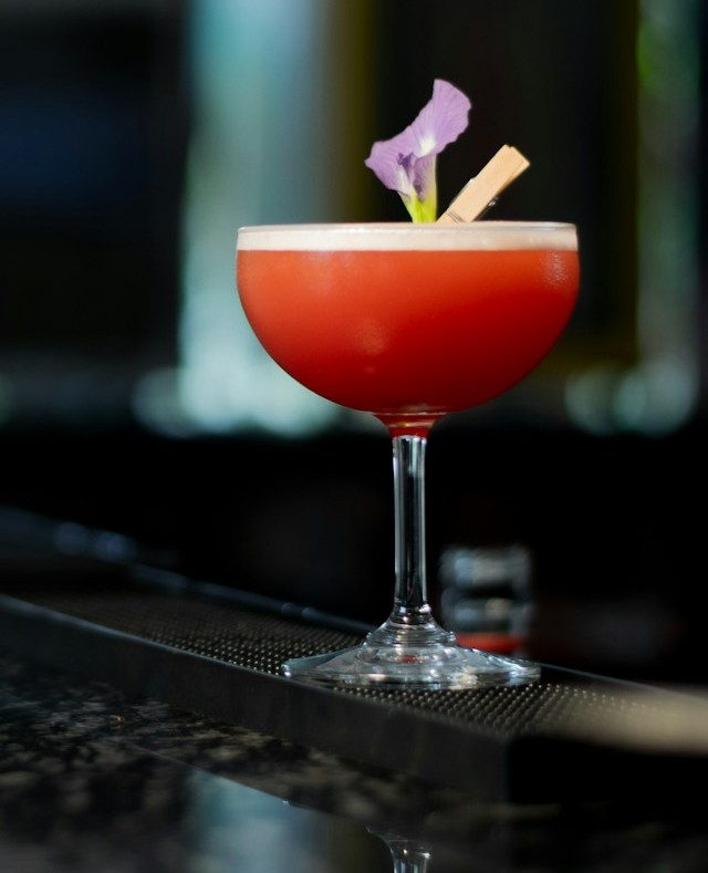 A colorful cocktail garnished with citrus